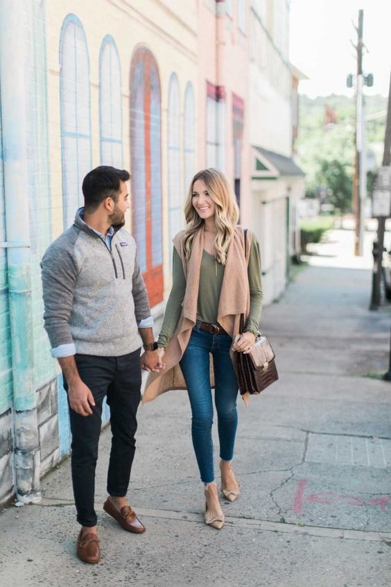 man and woman gazing at each other while walking on the street