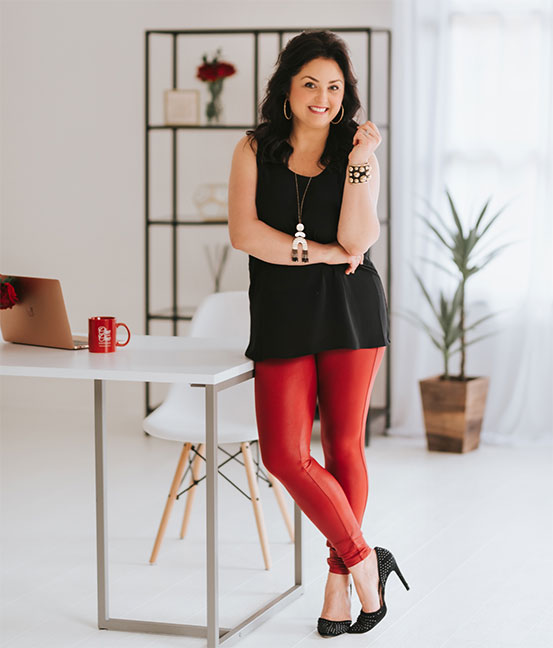 Professional photo of a business woman leaning on a desk
