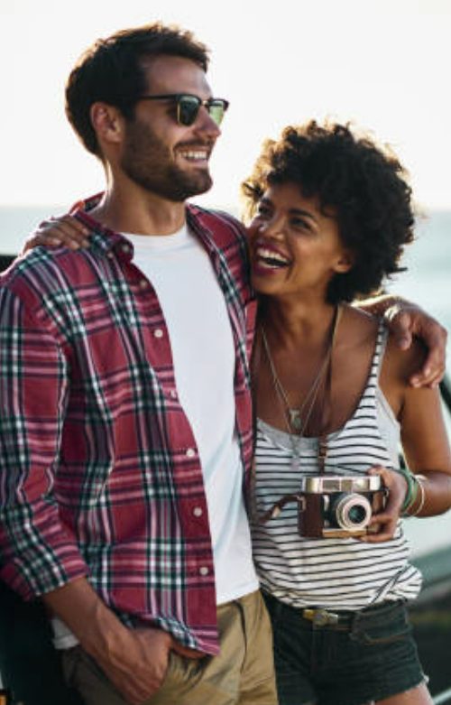 boyfriend & girlfriend laughing and smiling with each other.