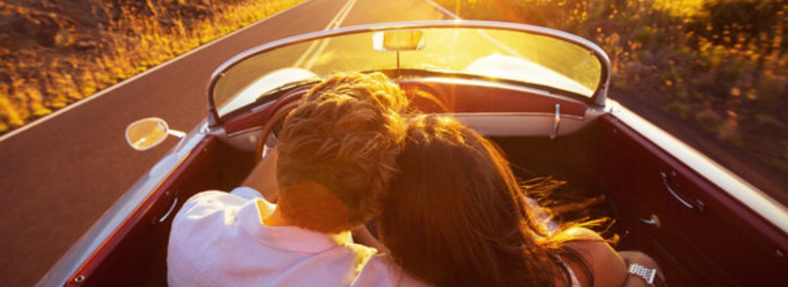 Couple driving at sunset. 