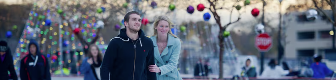 couple holding each other ice skating lovingly.