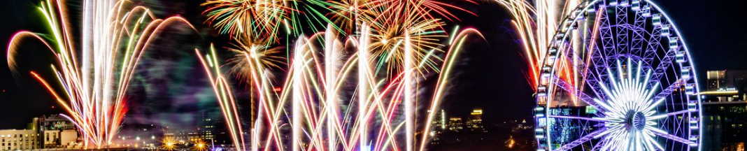 Fireworks in Atlanta near a ferris wheel.