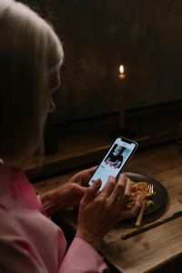 Single woman scrolling on a dating app on her phone.