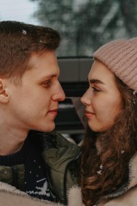 Couple looking at each other lovingly, being vulnerable with one another.